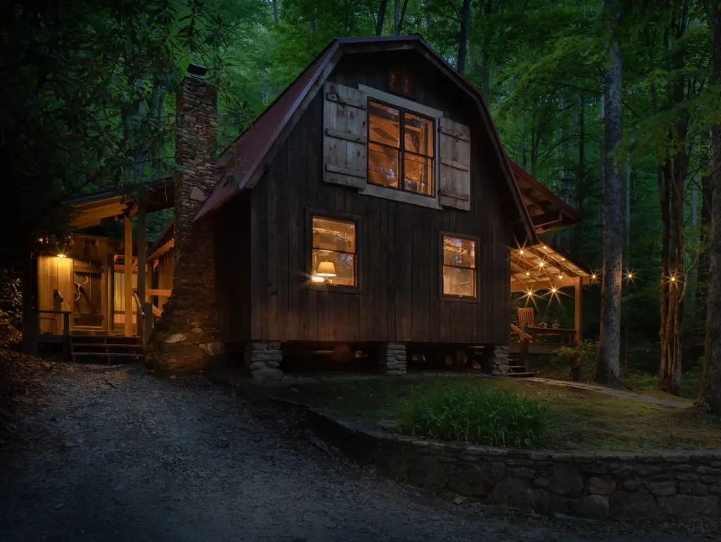 The Barn at Huffman Creek Retreat lit warmly at twilight, a peaceful venue for secluded yoga retreats north carolina.