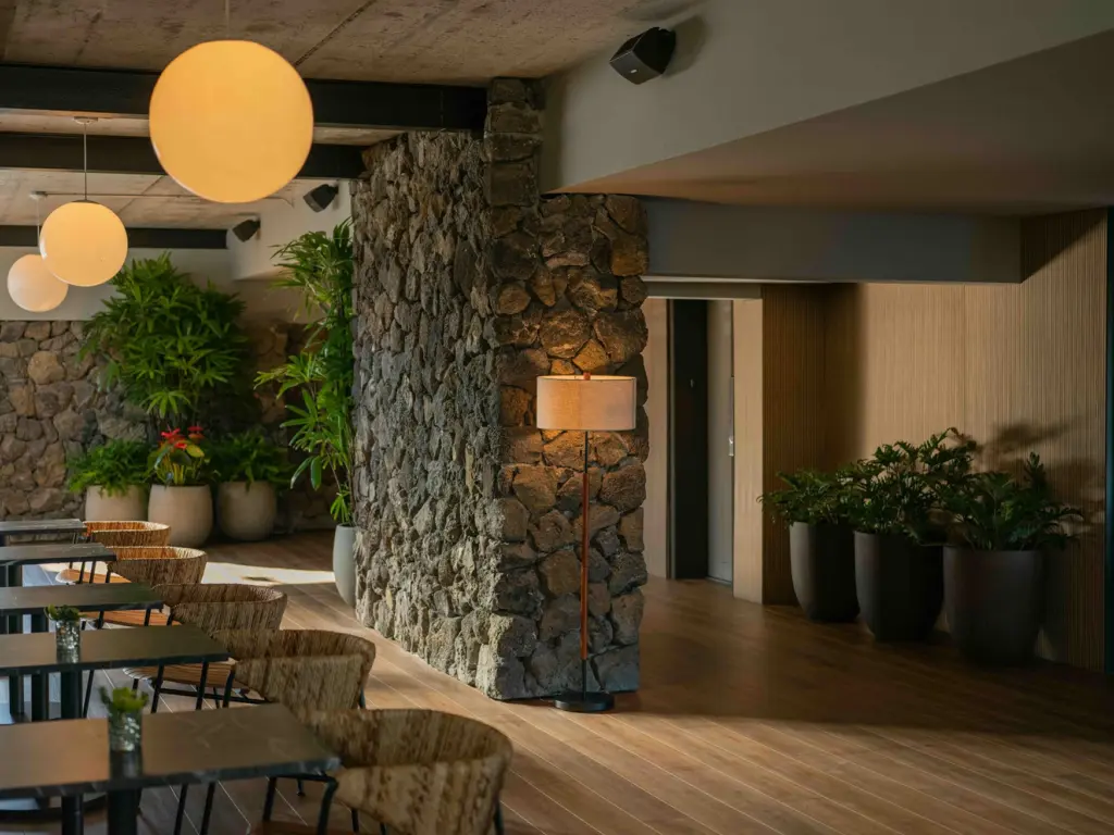 Stone accent wall and woven chairs in the modern lobby of one of the top design hotels kailua kona.