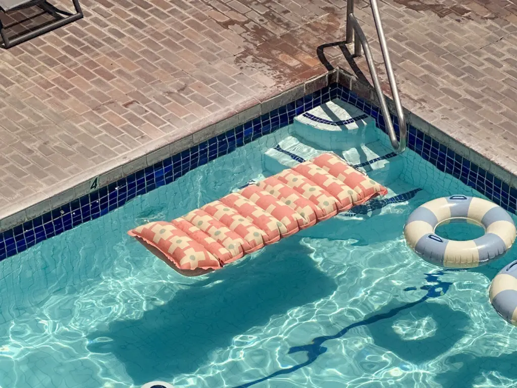 Sunny swimming pool with an orange float at Pacific 19, a standout among design hotels kailua kona.
