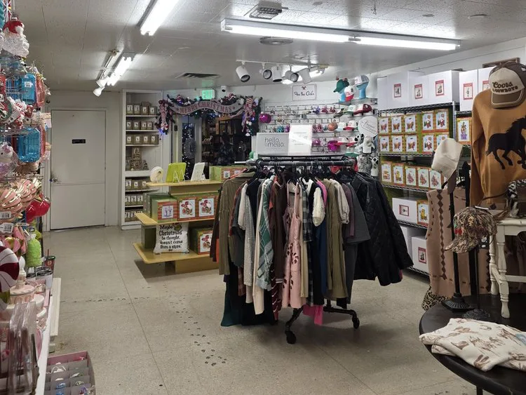 Clothing racks, holiday decor, and gift items inside a charming Fredericksburg, TX shop.