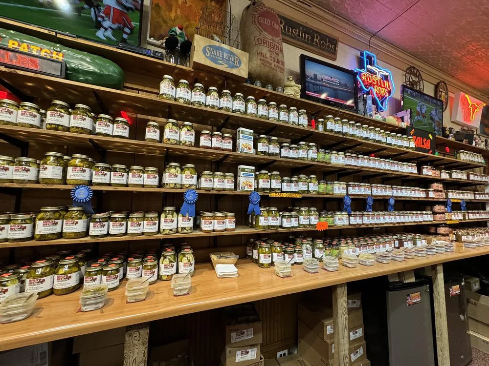 Award-winning pickles and salsas on wooden shelves at Rustlin' Rob's, one of the beloved shops in Fredericksburg TX.