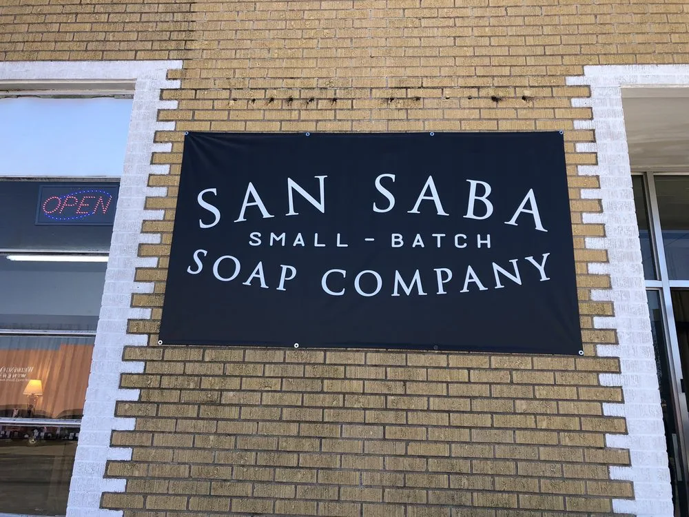 Handcrafted San Saba Soap Company products arranged on decorative trays at one of the charming shops in Fredericksburg, TX.