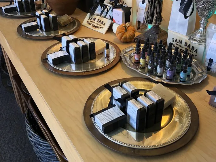 Handcrafted San Saba Soap Company products arranged on decorative trays at one of the charming shops in Fredericksburg, TX.