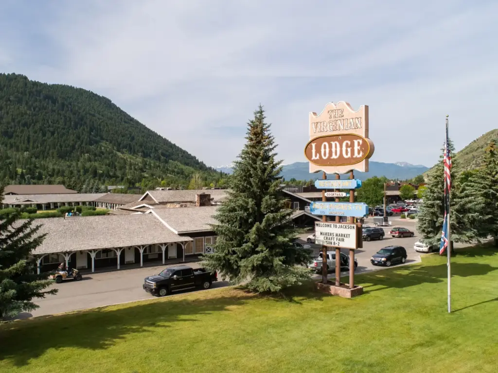 The Virginian Lodge sign in Jackson with mountain backdrop, parking lot, and low-rise motel buildings on a sunny day.
nature immersive corporate offsites