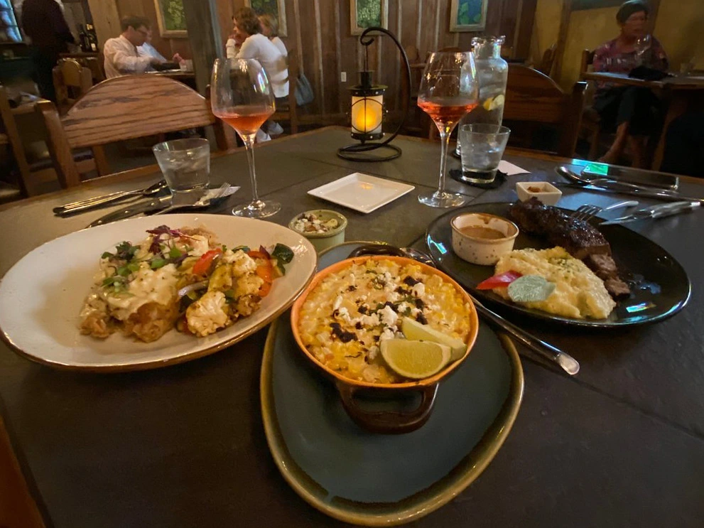 Table set with wine and dinner dishes at Cabernet Grill, one of the best restaurants in fredericksburg tx.