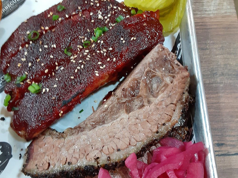 A tray of brisket and ribs from Eaker Barbecue, one of the best restaurants in fredericksburg tx.