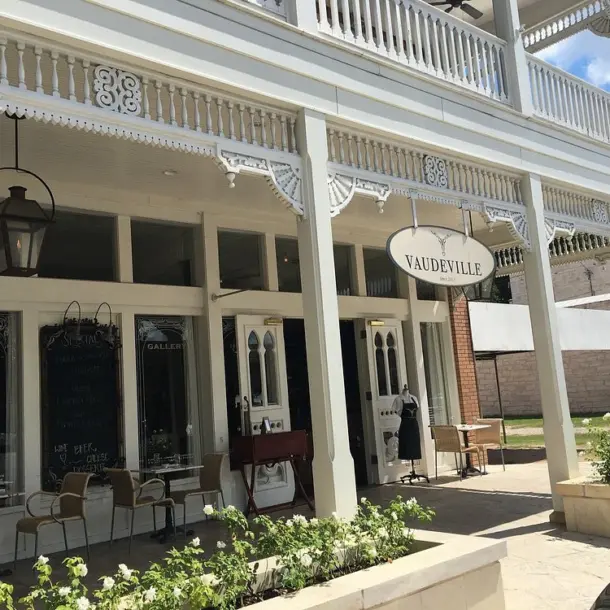 The historic white exterior of Vaudeville, considered one of the best restaurants in fredericksburg tx.